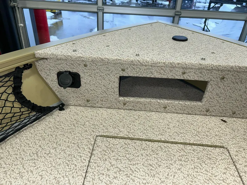 Slide: The Image of 2023 Crestliner 1650 Discovery Tiller boat interior with storage compartment and netting. - 16