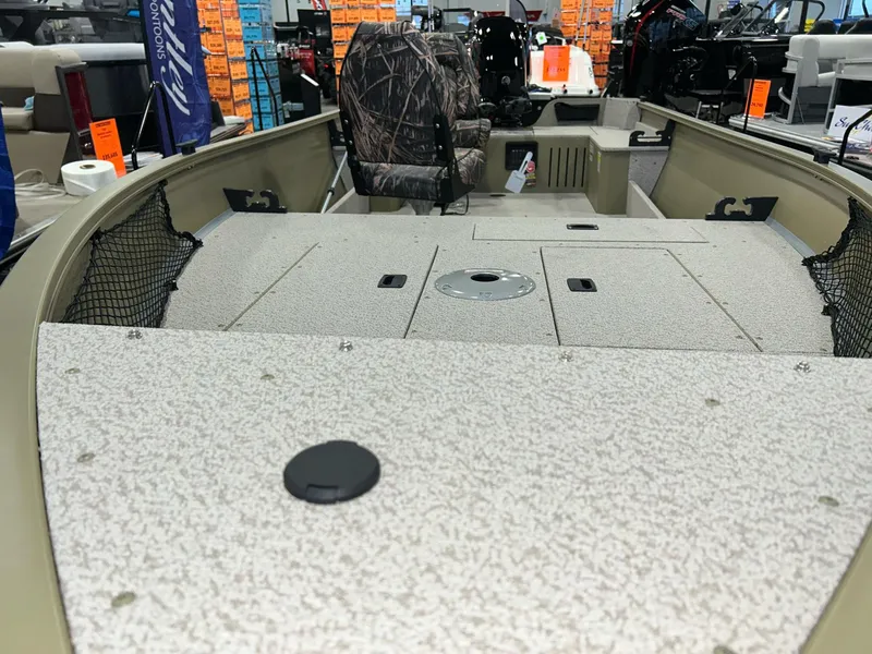 Slide: The Image of 2023 Crestliner 1650 Discovery Tiller boat interior with camo seat and storage compartments. - 17