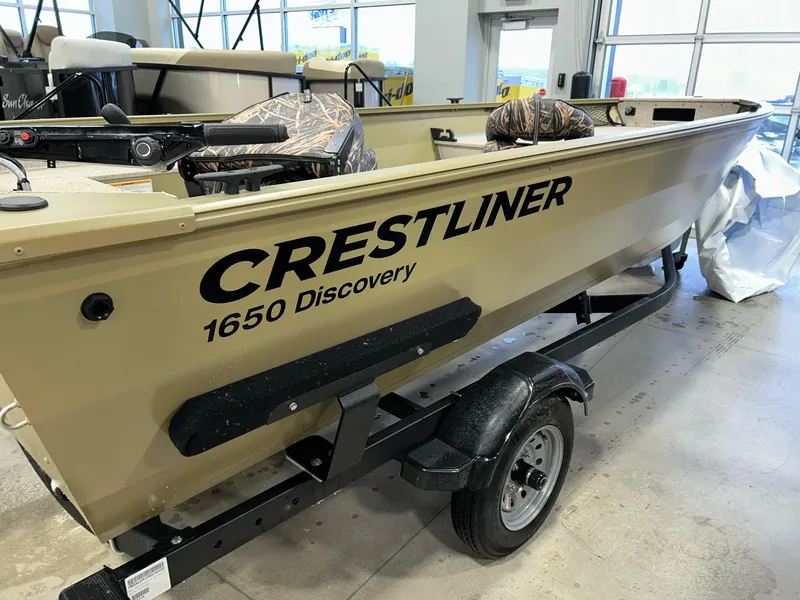 Slide: The Image of 2023 Crestliner 1650 Discovery Tiller boat on trailer in showroom. - 6