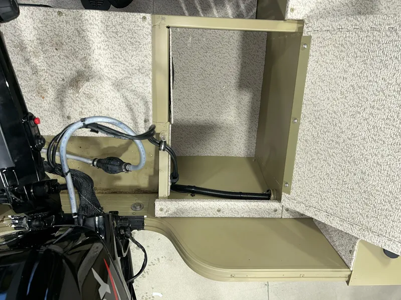 Slide: The Image of 2023 Crestliner 1650 Discovery Tiller interior showing engine compartment and wiring. - 9