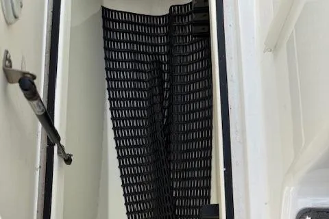 Slide: The Image of Storage compartment of 2015 Yamaha Boats SX210 with black mesh netting. - 13