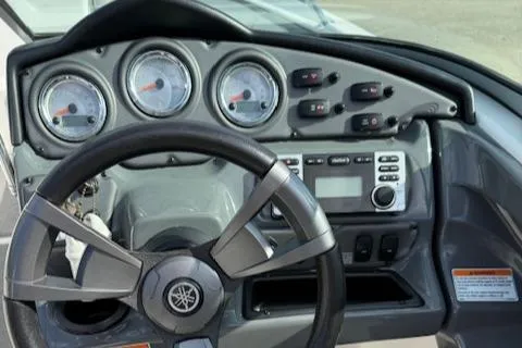 Slide: The Image of 2015 Yamaha Boats SX210 dashboard with steering wheel and control panel. - 8