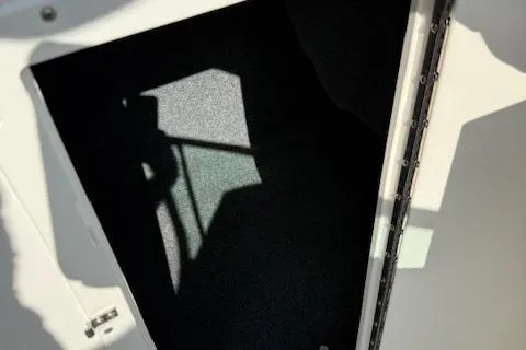 Slide: The Image of 2015 Yamaha Boats SX210 storage compartment with shadowed interior. - 9