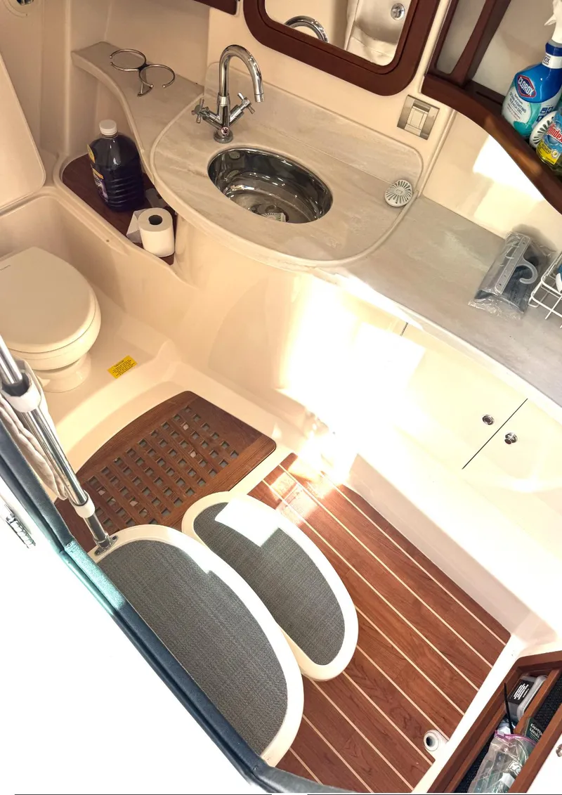 Slide: The Image of Luxurious 2019 Grady-White Freedom 375 boat bathroom with sink, toilet, and wooden flooring. - 10