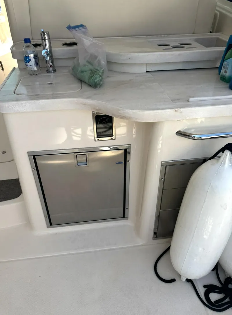 Slide: The Image of 2019 Grady-White Freedom 375 boat interior with kitchenette and storage compartments. - 12