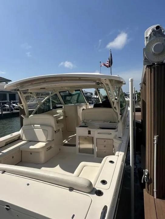 Slide: The Image of 2019 Grady-White Freedom 375 boat docked, featuring spacious seating and sleek design. - 21