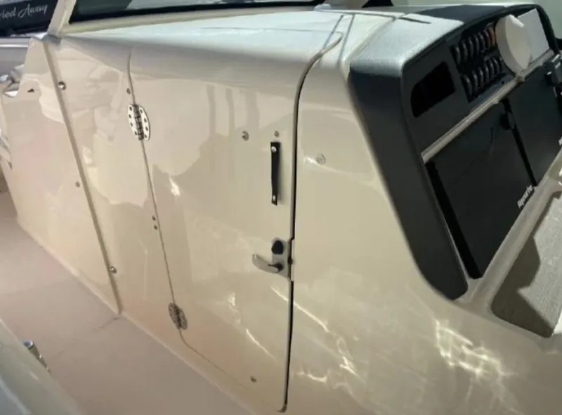 Slide: The Image of 2019 Grady-White Freedom 375 boat interior, featuring control panel and storage compartment. - 25