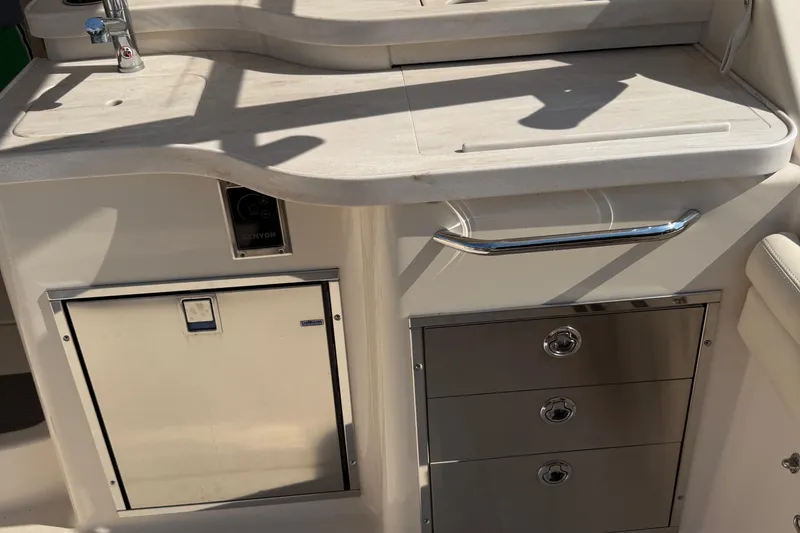 Slide: The Image of 2019 Grady-White Freedom 375 boat interior with sink, storage drawers, and countertop. - 26