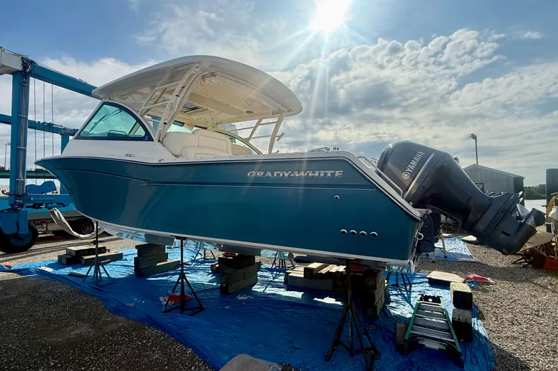Slide: The Image of 2019 Grady-White Freedom 375 boat on stands under a bright sky. - 3