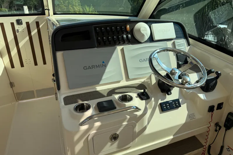 Slide: The Image of 2019 Grady-White Freedom 375 helm with Garmin navigation system and steering wheel. - 35