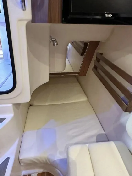 Slide: The Image of Interior cabin of 2019 Grady-White Freedom 375 boat with cushioned seating and wood accents. - 47