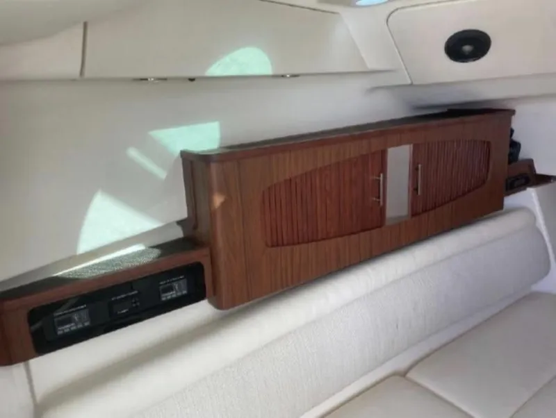 Slide: The Image of 2019 Grady-White Freedom 375 interior with wooden cabinetry and cushioned seating. - 48