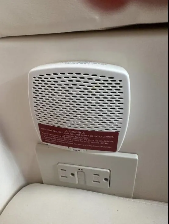 Slide: The Image of Carbon monoxide detector and power outlet on 2019 Grady-White Freedom 375 boat interior. - 49