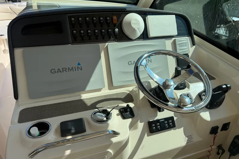 Slide: The Image of 2019 Grady-White Freedom 375 boat dashboard with Garmin navigation system and steering wheel. - 51