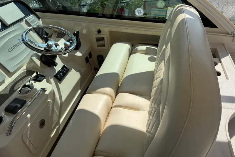 Slide: The Image of 2019 Grady-White Freedom 375 boat interior with steering wheel and beige seating. - 52