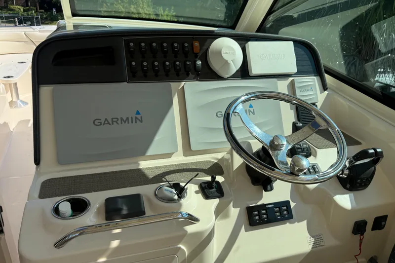 Slide: The Image of 2019 Grady-White Freedom 375 boat dashboard with Garmin navigation system and steering wheel. - 54