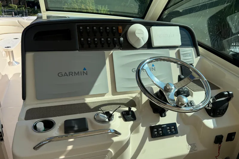 Slide: The Image of 2019 Grady-White Freedom 375 boat dashboard with Garmin navigation system and steering wheel. - 55
