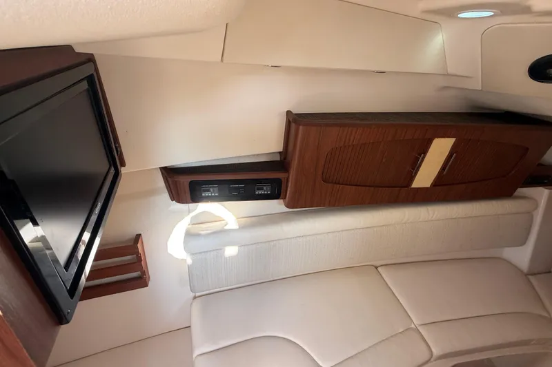 Slide: The Image of Interior of 2019 Grady-White Freedom 375 boat with TV and wooden cabinetry. - 61