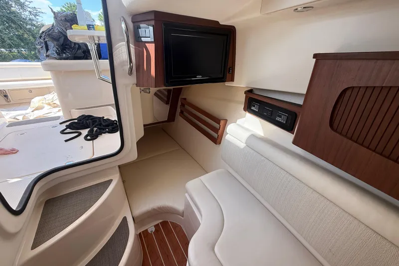 Slide: The Image of 2019 Grady-White Freedom 375 cabin interior with seating and TV. - 62