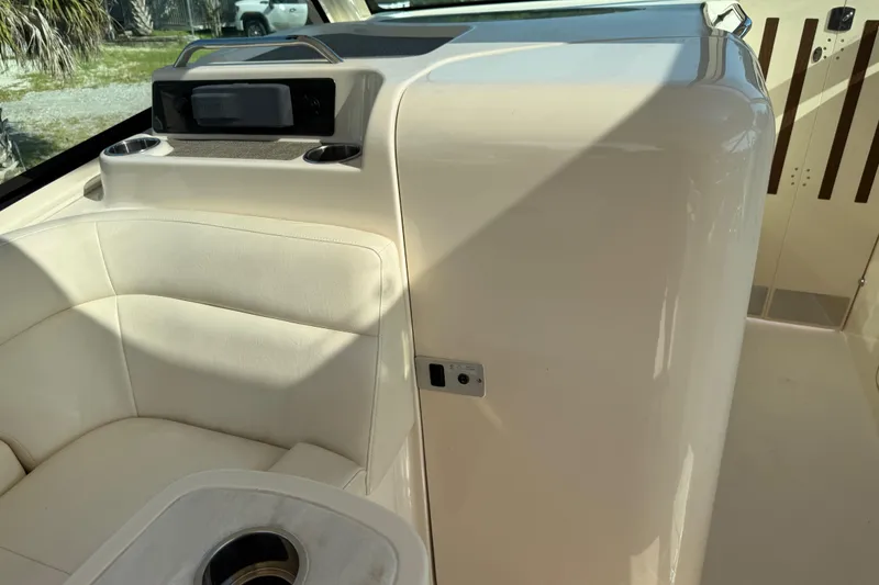 Slide: The Image of Interior of 2019 Grady-White Freedom 375 boat, featuring white seating and cup holders. - 66
