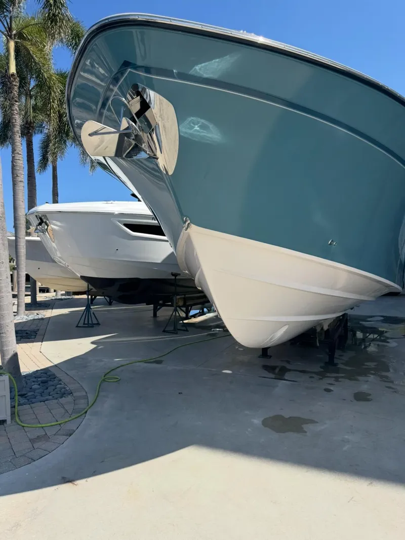 Slide: The Image of 2019 Grady-White Freedom 375 boat on display, sunny day, palm trees in background. - 7