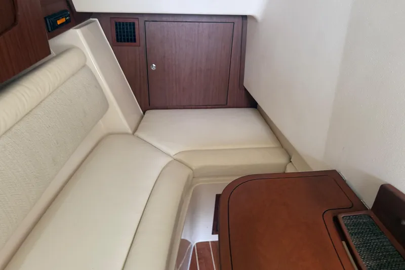 Slide: The Image of 2019 Grady-White Freedom 375 cabin interior with beige seating and wooden accents. - 74