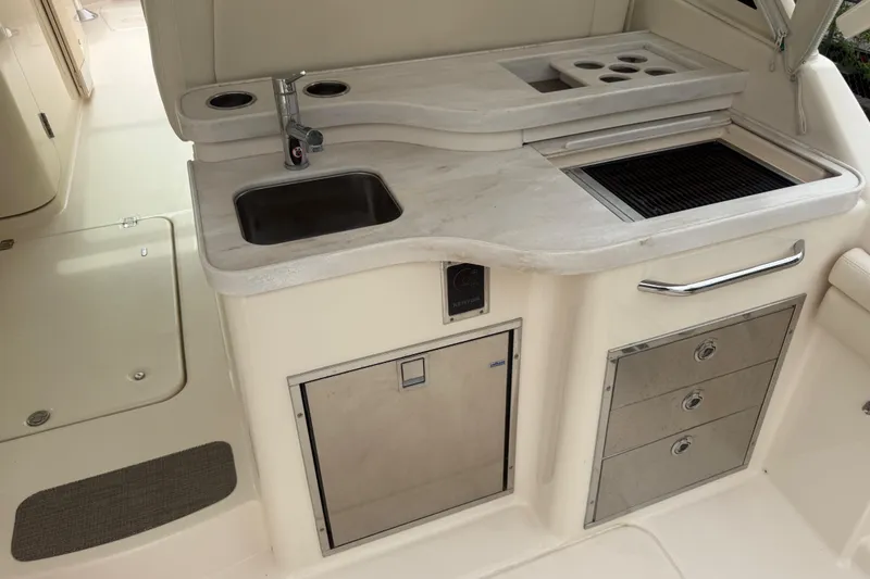 Slide: The Image of 2019 Grady-White Freedom 375 boat kitchenette with sink, grill, and storage drawers. - 75
