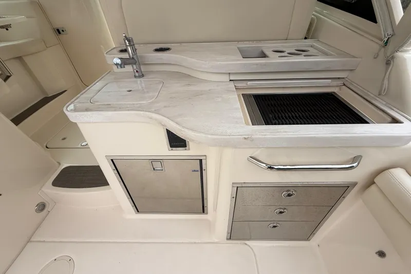 Slide: The Image of 2019 Grady-White Freedom 375 boat kitchen with sink, grill, and storage drawers. - 76
