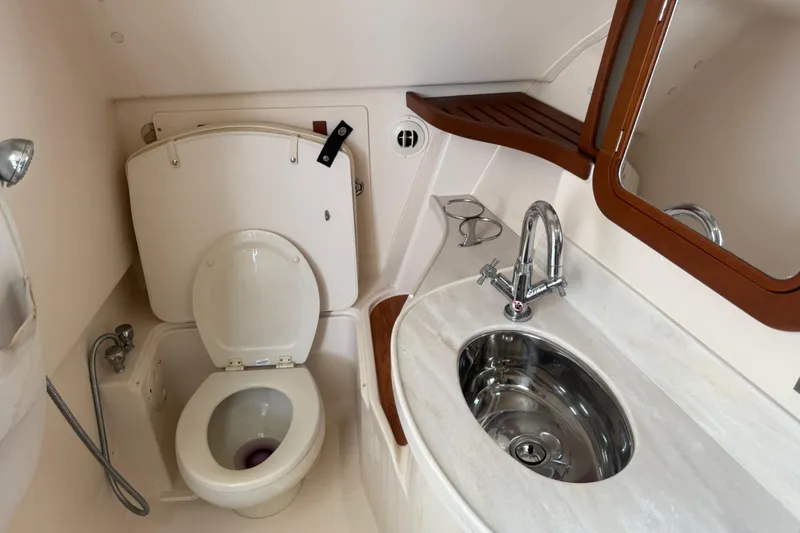Slide: The Image of 2019 Grady-White Freedom 375 boat bathroom with toilet, sink, and mirror. - 77