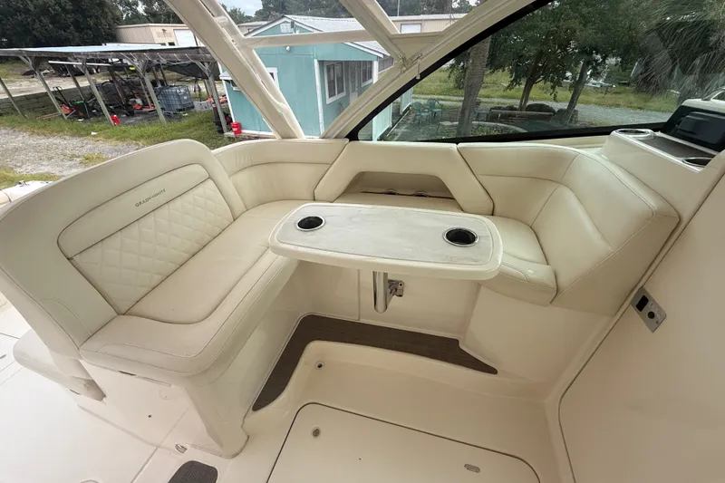 Slide: The Image of Luxurious seating area on 2019 Grady-White Freedom 375 boat with table and cup holders. - 79