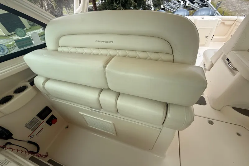 Slide: The Image of 2019 Grady-White Freedom 375 boat interior with cushioned seating and control panel. - 82