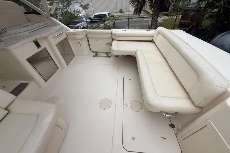 Slide: The Image of 2019 Grady-White Freedom 375 boat interior with beige seating and storage compartments. - 83