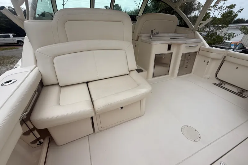 Slide: The Image of 2019 Grady-White Freedom 375 boat interior with white seating and kitchenette. - 84
