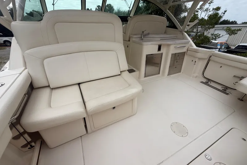 Slide: The Image of 2019 Grady-White Freedom 375 boat interior with white seating and kitchenette area. - 85