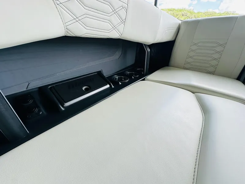 Slide: The Image of 2023 Malibu 25LSV interior with white leather seats and cup holders. - 22