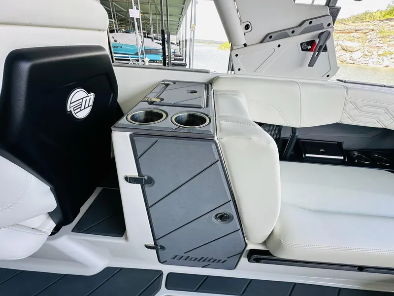 Slide: The Image of 2023 Malibu 25LSV boat interior with cup holders and white seating. - 24