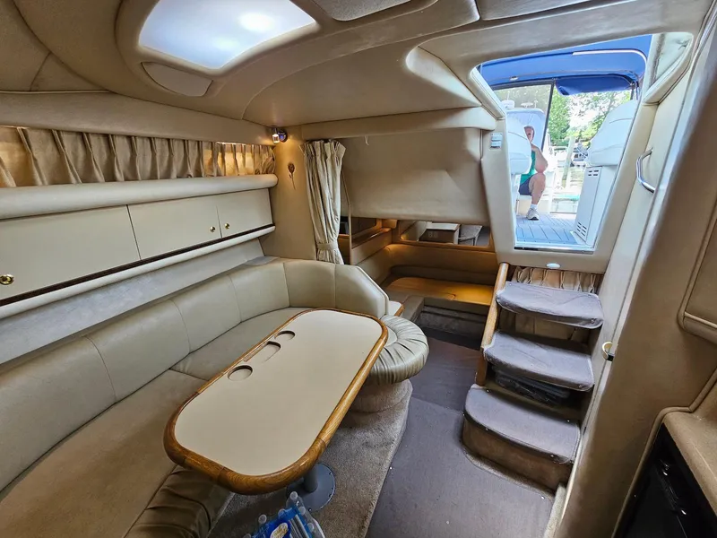 Slide: The Image of Interior of 1998 Sea Ray 330 Sundancer yacht, featuring cozy seating and elegant design. - 12