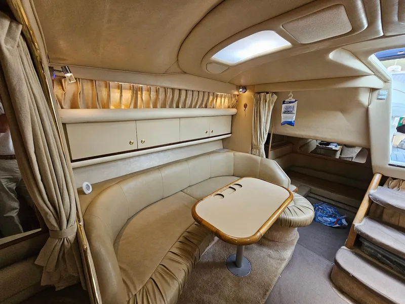 Slide: The Image of Interior of 1998 Sea Ray 330 Sundancer yacht with beige seating and table. - 13