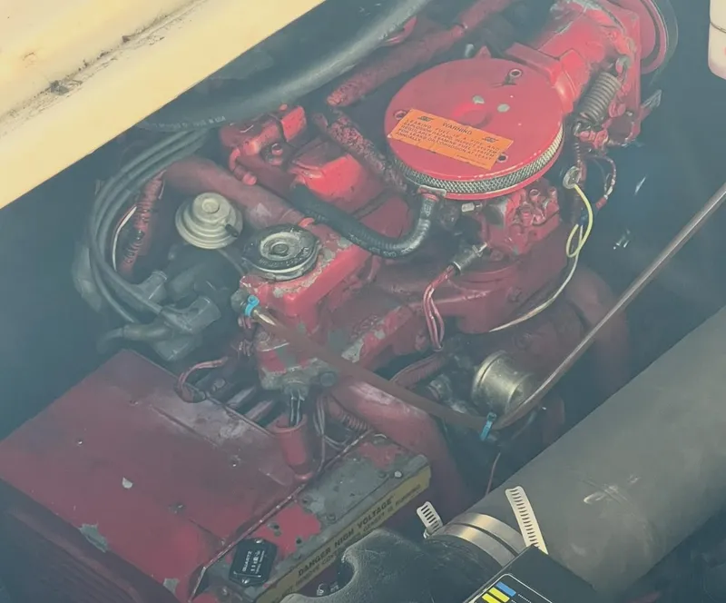 Slide: The Image of Engine compartment of a 1998 Sea Ray 330 Sundancer boat, featuring red components. - 19