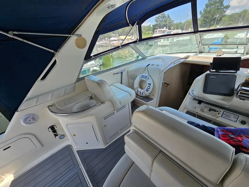 Slide: The Image of 1998 Sea Ray 330 Sundancer interior with helm, seating, and lake view. - 8