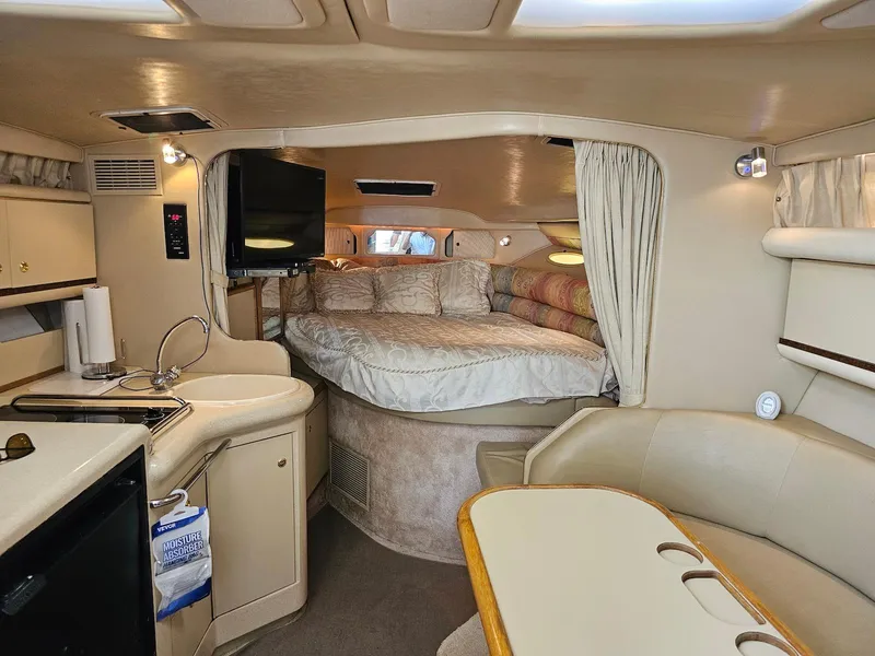 Slide: The Image of Interior of 1998 Sea Ray 330 Sundancer yacht with cozy cabin and kitchenette. - 9
