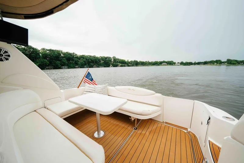 Slide: The Image of 2000 Sea Ray 340 Sundancer yacht interior with seating, table, and lake view. - 13
