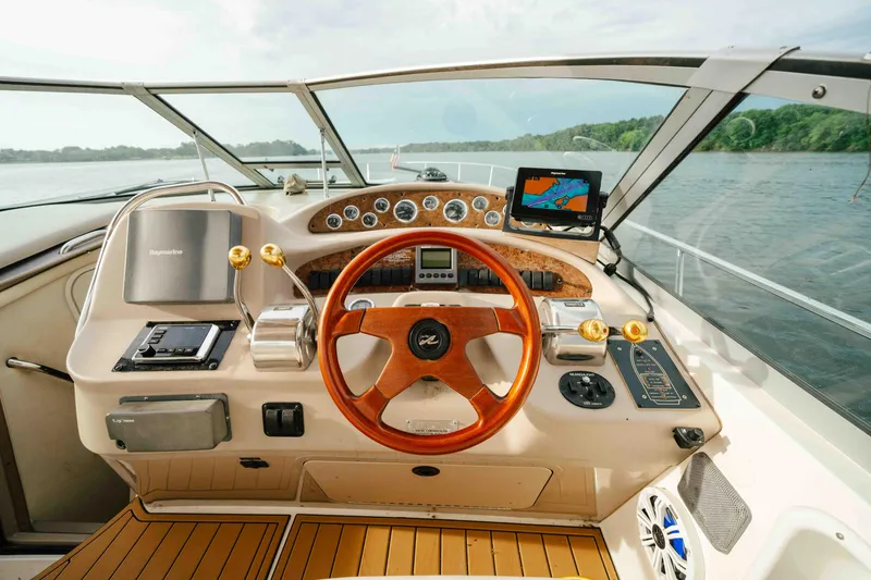 Slide: The Image of Helm of 2000 Sea Ray 340 Sundancer with wooden steering wheel and navigation equipment. - 18