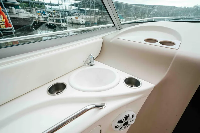 Slide: The Image of 2000 Sea Ray 340 Sundancer boat interior with sink and cup holders. - 19