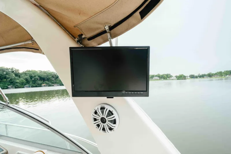 Slide: The Image of Flat-screen TV and speaker on 2000 Sea Ray 340 Sundancer boat, overlooking serene lake. - 22