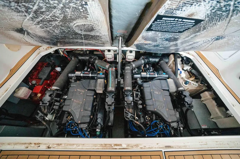 Slide: The Image of Engine compartment of a 2000 Sea Ray 340 Sundancer boat, showcasing dual engines. - 24