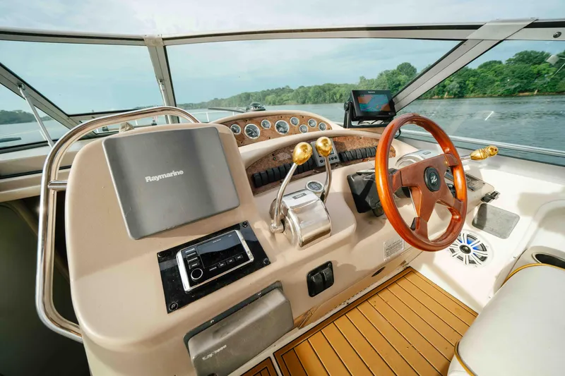 Slide: The Image of Cockpit of 2000 Sea Ray 340 Sundancer with steering wheel and navigation equipment. - 27