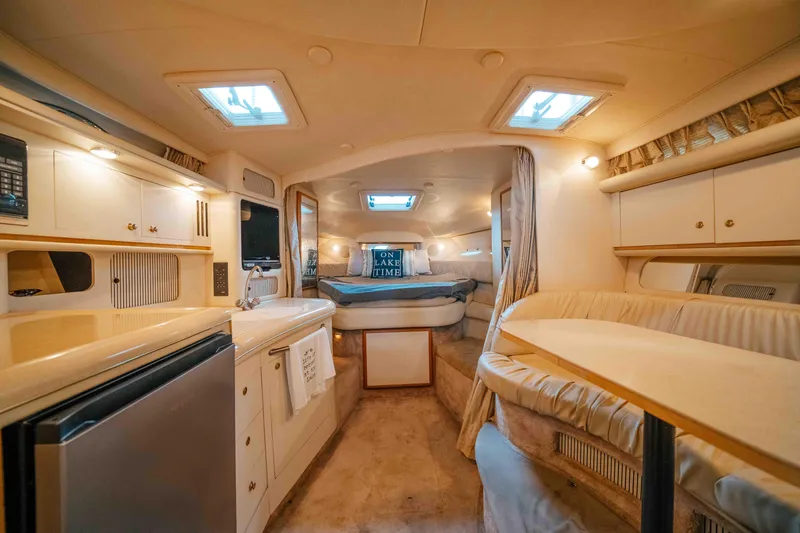 Slide: The Image of Interior of 2000 Sea Ray 340 Sundancer yacht, featuring cozy seating and modern amenities. - 29