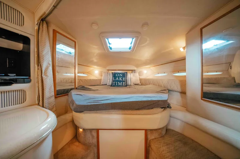 Slide: The Image of Cozy cabin interior of 2000 Sea Ray 340 Sundancer with bed and skylight. - 32