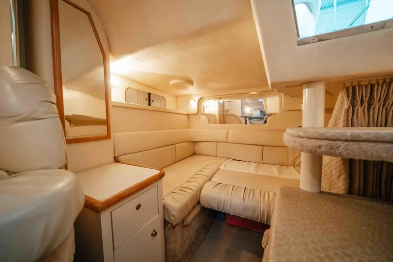 Slide: The Image of Interior of 2000 Sea Ray 340 Sundancer, featuring cozy seating and elegant design. - 34
